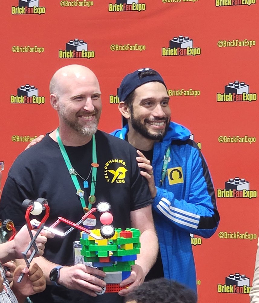 Two members sharing a colorful LEGO® build
