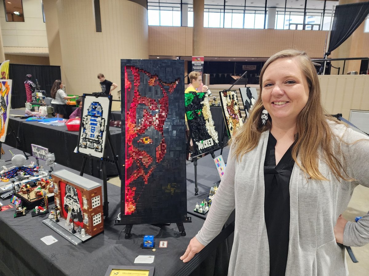 A member beside her LEGO® display