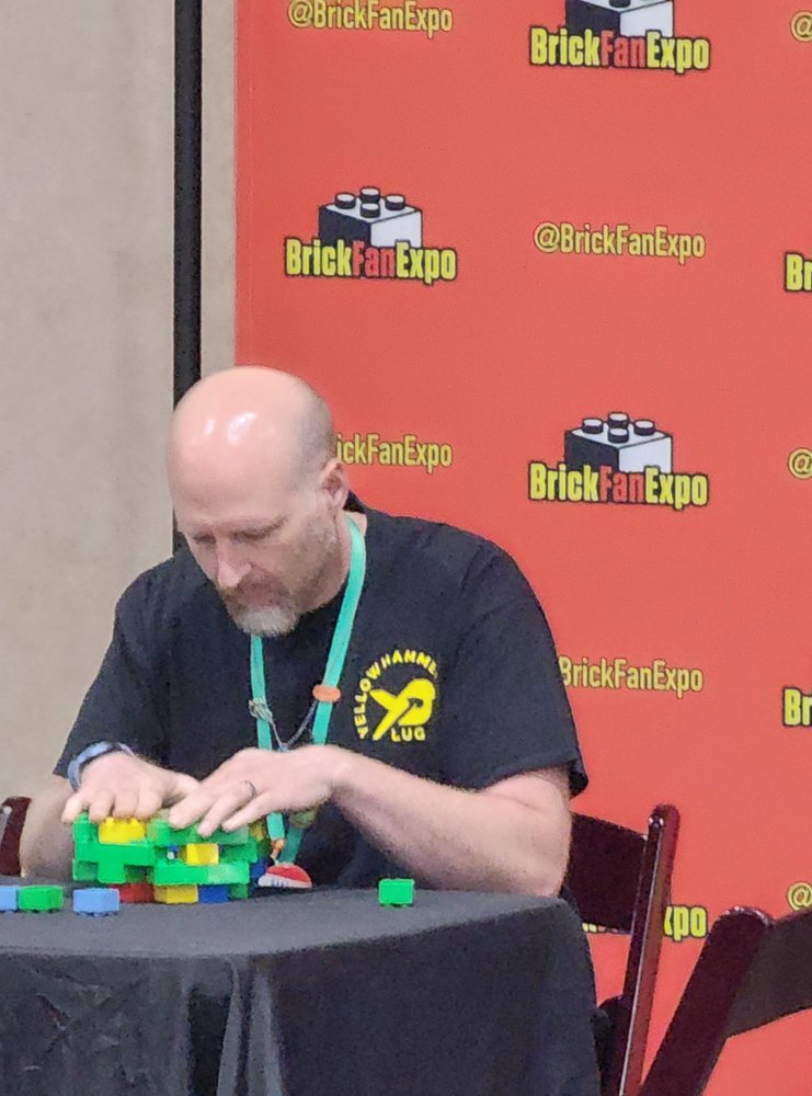 A member working on a colorful LEGO® build