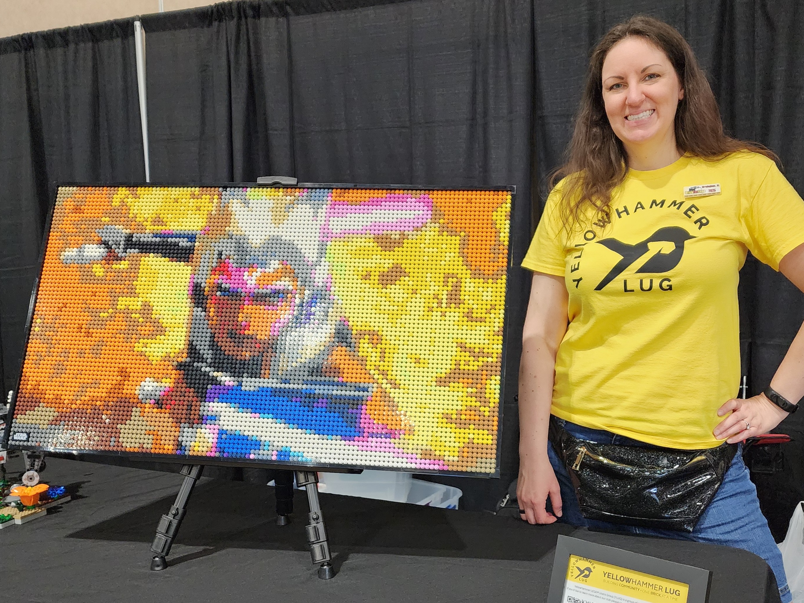 Member posing with LEGO® mosaic